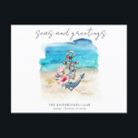 Tropical Coastal Beach Christmas Holiday Card<br><div class="desc">Tropical Coastal Beach Christmas Holiday Card - Beachy Christmas Postcard features an anchor adorned with tropical flowers and silver bells with a watercolor beach background. Modern script typography reads " Seas and Greetings" and is personalized with your family name or business name with year and family member's names. The back...</div>