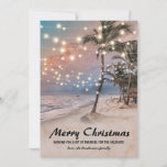 Tropical Coastal Beach Christmas Holiday Card<br><div class="desc">Vintage beach christmas holiday card featuring a sunset tropical beach setting with lush palm trees,  string twinkle lights,  seasons greetings,  and your name.</div>