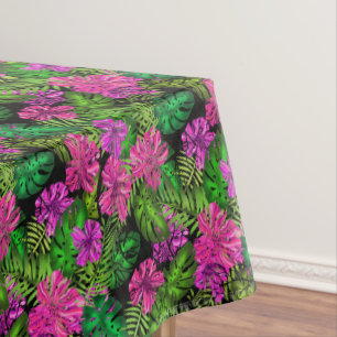 Tropical flowers and plants on black tablecloth