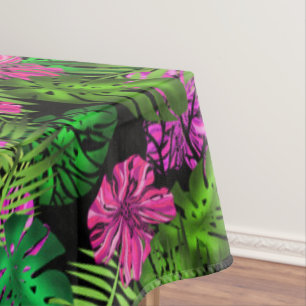 Tropical flowers and plants on black tablecloth