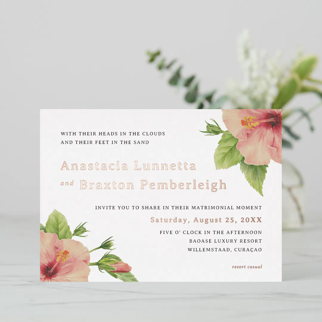 The invitation design illustrates hibiscus flowers in the top right and bottom left corner. There's real foil and standard text printed on the invitation in shades rose gold and black. The background has a white marble-like effect.