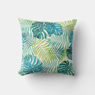 Tropical leaf design featuring green/blue palm and throw pillow