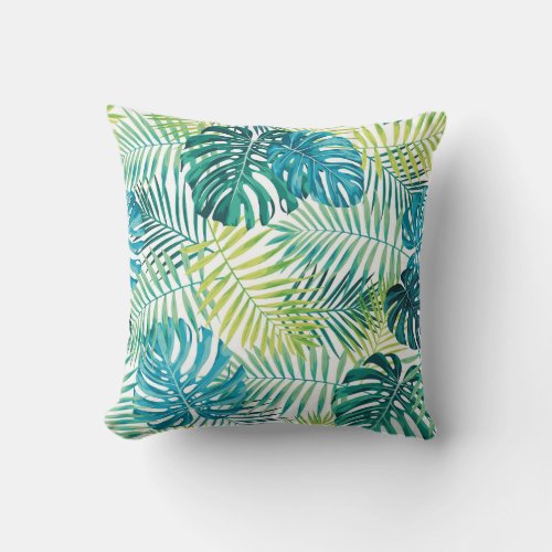 Tropical leaf design featuring greenblue palm and throw pillow