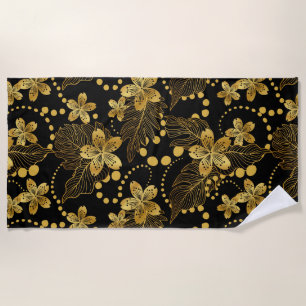 tropical leaves & flowers pattern in gold on black beach towel