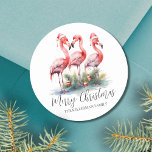 Tropical Merry Christmas Classic Round Sticker<br><div class="desc">Tropical Pink Flamingo Merry Christmas Classic Round Sticker. Celebrate the holidays with a tropical twist using this festive round sticker featuring three pink flamingos wearing Santa hats, accented with ornaments at the base. Ideal for spreading beachy holiday cheer, this sticker is perfect for those in tropical places like Florida, Hawaii,...</div>