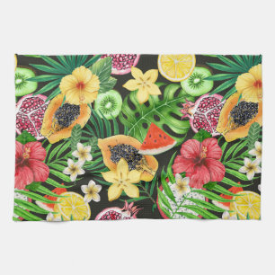 Tropical mix-fruit, flowers and leaves on black kitchen towel
