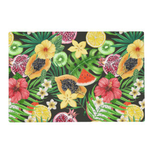 Tropical mix-fruit, flowers and leaves on black placemat