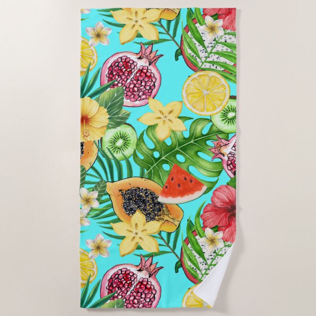 Tropical mix-fruit, flowers and leaves on blue beach towel (Front)