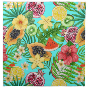 Tropical mix-fruit, flowers and leaves on blue cloth napkin