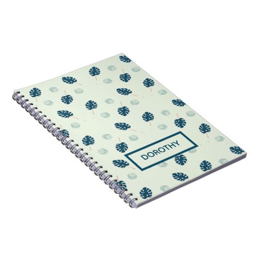 Tropical monstera leaves monogram on blue notebook