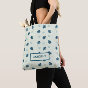 Tropical monstera leaves monogram on blue tote bag