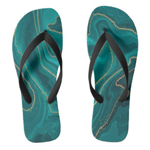 Turquoise liquid marble background with gold flip flops