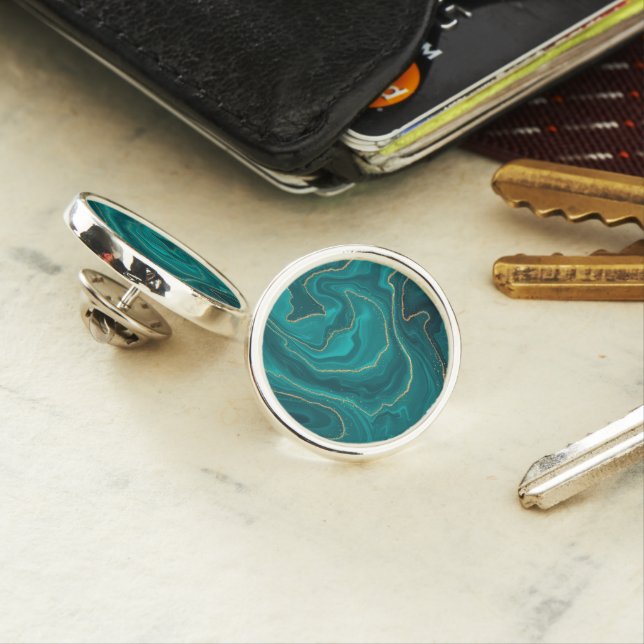 Turquoise liquid marble background with gold lapel pin (In Situ)