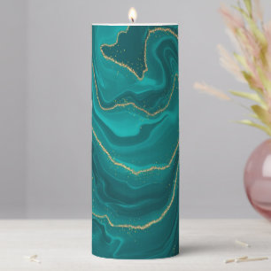 Turquoise liquid marble background with gold pillar candle