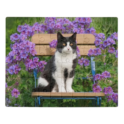 Tuxedo cat sitting on a garden chair with flowers jigsaw puzzle
