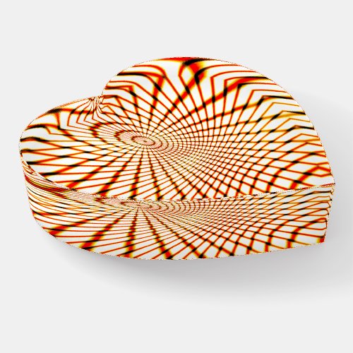 Twisted crossed orange lines forming sunken circle paperweight