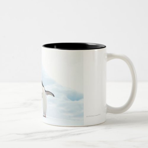 Two Adelie Penguins sitting on a sheet of ice Two_Tone Coffee Mug