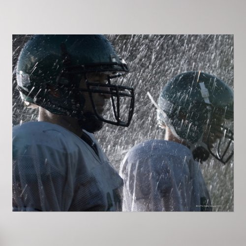 Two American football players in rain side view Poster