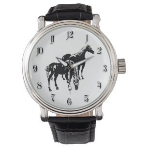 Two black horses watch