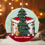 Two Corgi Tricolor Red White Santa Hat Christmas Ceramic Ornament<br><div class="desc">This beautiful Pembroke Welsh Corgi dog ornament features two dogs wearing Santa Claus hats with an adorable head tilt. One tricolor pup and one red and white doggy sitting in front of a pretty Christmas tree decorated with colorful ornaments. Personalize your pet's names in lovely cursive under the wonderful drawing...</div>