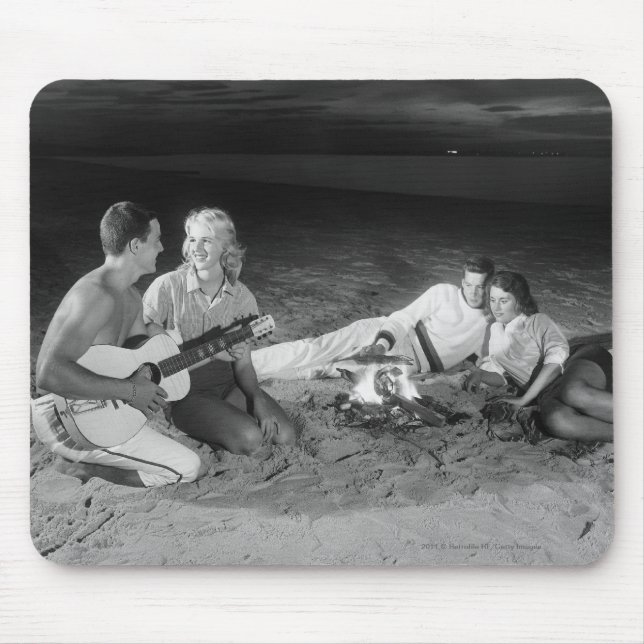 Two couples on beach sitting around campfire mouse pad (Front)