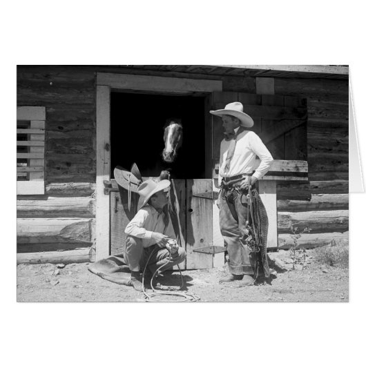 Two cowboys standing next to a barn with a horse (Front Horizontal)