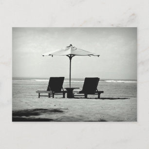 Two deck chairs on a beach postcard