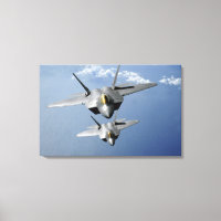 Two F-22 Raptors fly over the Pacific Ocean