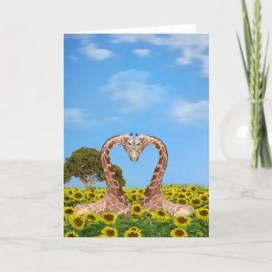 Two giraffes in a field of sunflowers holiday card
