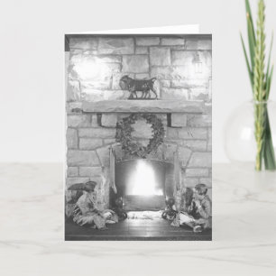 Two girls sitting by a fireplace at Christmas Holiday Card