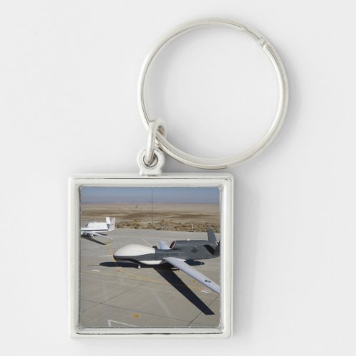 Two Global Hawks parked on a ramp Keychain