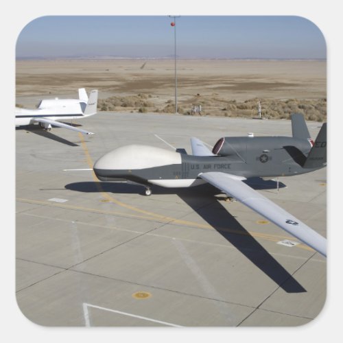 Two Global Hawks parked on a ramp Square Sticker