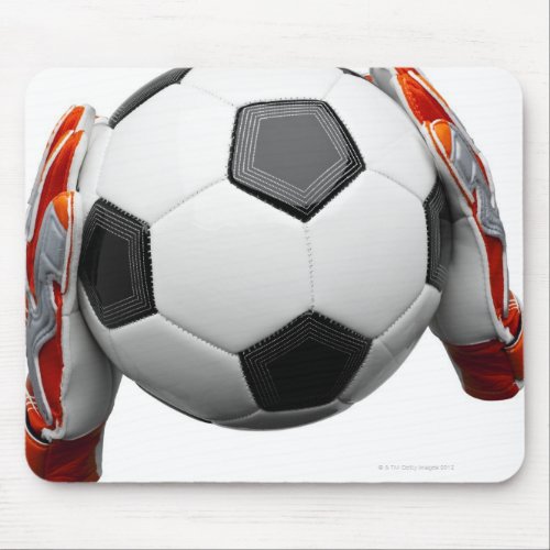 Two goal keepers gloves holding a football mouse pad