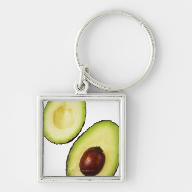 Two halves of an an avocado, on white keychain (Front)