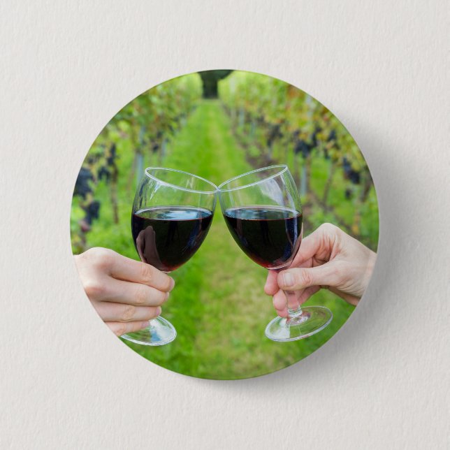 Two hands toasting with wine glasses in vineyard button (Front)