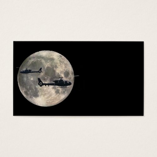two helicopters silhouetted by a full moon business card