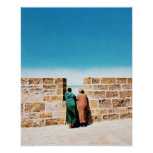 Two Men Gazing Over Wall Toward Bright Blue Sky