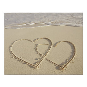 Two overlying hearts drawn on the beach faux canvas print