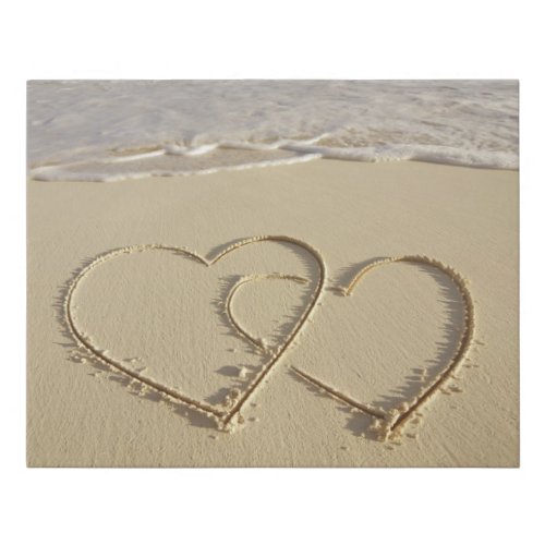 Two overlying hearts drawn on the beach faux canvas print