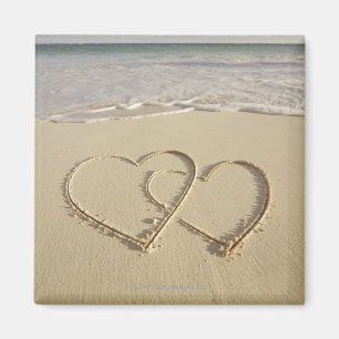 Two overlying hearts drawn on the beach magnet