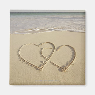 Two overlying hearts drawn on the beach magnet