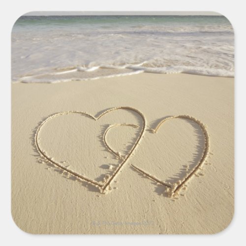 Two overlying hearts drawn on the beach square sticker