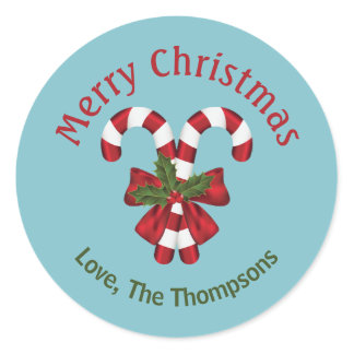 Two Red And White Candy Canes On Blue With Text Classic Round Sticker