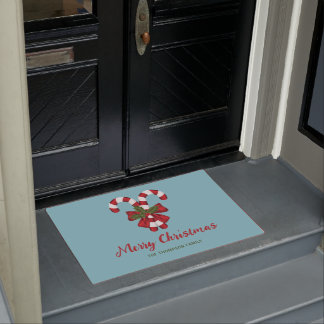 Two Red And White Candy Canes On Blue With Text Doormat