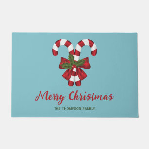 Two Red And White Candy Canes On Blue With Text Doormat
