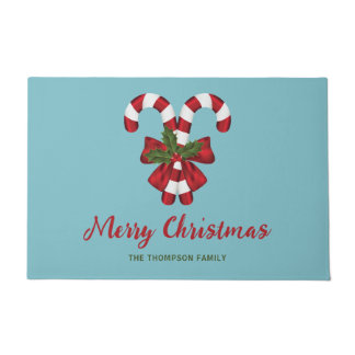 Two Red And White Candy Canes On Blue With Text Doormat