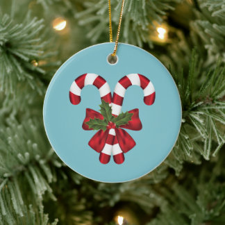 Two Red And White Festive Candy Canes On Blue Ceramic Ornament