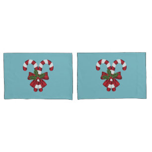 Two Red And White Festive Candy Canes On Blue Pillow Case