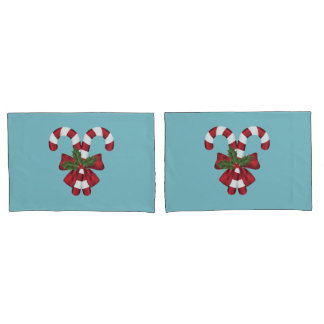 Two Red And White Festive Candy Canes On Blue Pillow Case