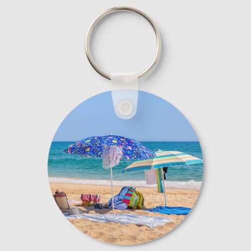 Two sun umbrellas and beach supplies at seaJPG Keychain